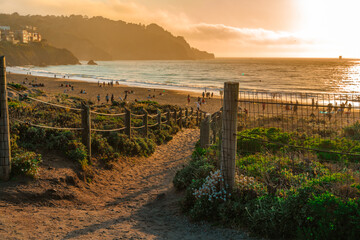 The promenade and beach in front of the Golden Gate Bridge at sunset, San Francisco