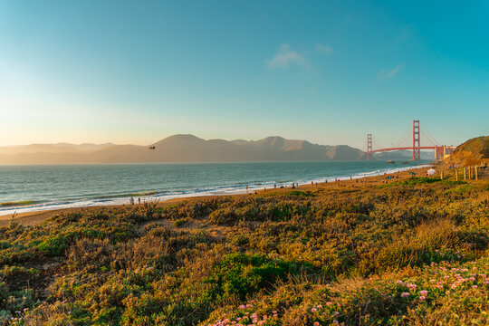 The promenade and beach in front of the Golden Gate Bridge at sunset, San Francisco