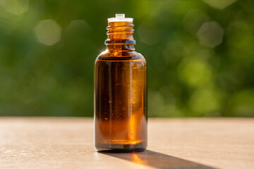 Cosmetic oil. Herbal essence. Alternative health medicine. Skin care. Summer on the background of boke.