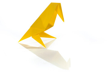 Origami bird made of colored paper isolated on white background