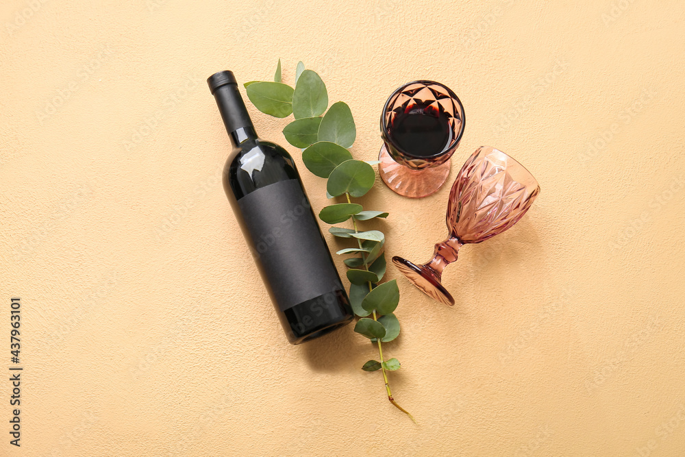 Wall mural bottle of wine and glasses on color background