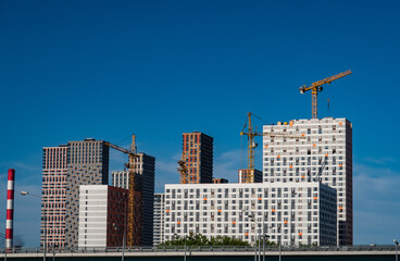 view of new residential buildings under construction against the blue sky