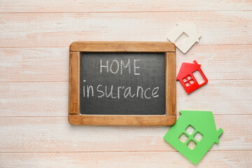 Composition with text HOME INSURANCE on light wooden background