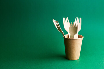 Eco friendly disposable dishes on green background. Sustainable lifestyle concept. zero waste,...