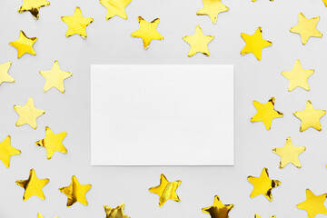 Blank paper sheet and confetti on light background