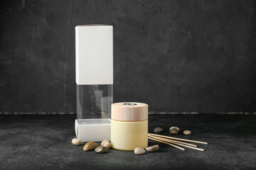 Reed diffuser with sea stones on dark background
