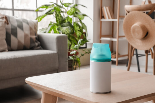 Bottle of air freshener on table in living room