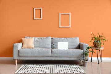 Stylish interior of living room with cozy sofa