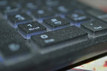 Dusty black PC keyboard close-up in the evening