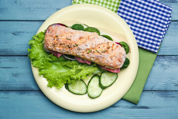 Plate with tasty ciabatta sandwich on color wooden background