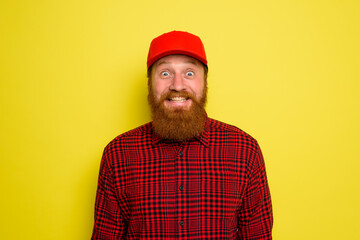 Delivery man with hat and beard has an happy expression