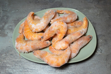 Frozen Tasty Shrimps background..Prawns in ice, healthy seafood, close up photo. Food preparing.