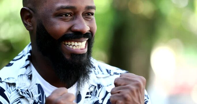 Happy ecstatic black man celebrating success goal reached