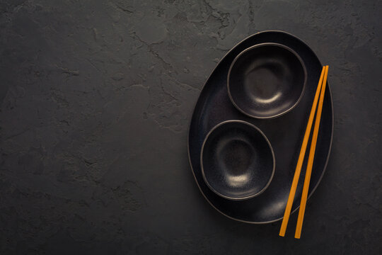 Pottery bowls or ceramics in blacke tone with chopsticks