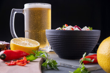 a mug of cold beer and a bowl of ceviche