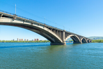 Obraz na płótnie Canvas View on Bridge Communal from embankment of the Yenisei river in Krasnoyarsk, Russia in sunny day