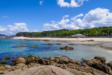 Samil beach in Vigo, Galicia, Pontevedra, Spain. Rocks, sea, trees and a restaurant