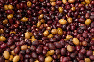 Brown kalamata olives. Closeup textire. Some green olive.