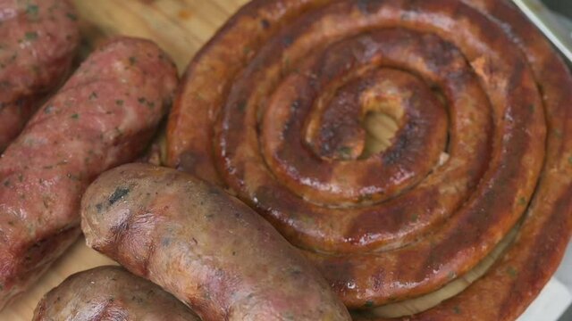 Grilled with rib of beef, chistorra and sausages. Golden sausages ready for the celebration of the picnic. Charcoal grill concept.