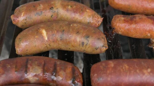 Grilled with rib of beef, chistorra and sausages. Golden sausages ready for the celebration of the picnic. Charcoal grill concept.