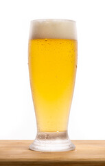 Glass of beer on a wooden table over white background