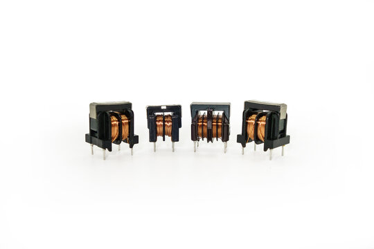 Ferrite core inductors with two windings, arranged in line. White background
