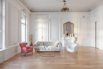 very light baroque style luxury interior of big sitting room. White walls decorated with awesome...