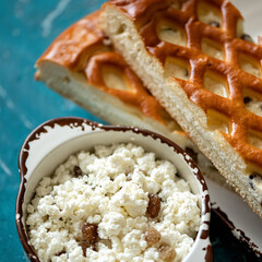 Homemade Open pie with cottage cheese and raisins cooking process. Close up shot. Soft focus. Top view.