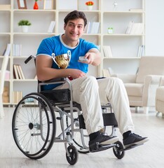 Fototapeta na wymiar Disabled man watching sports on tv