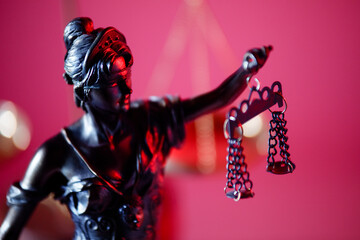 Judgment and law concept. Figure of Lady Justice on red background