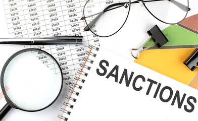 SANCTIONS - the inscription of text on the Notepad, and chart. Business concept