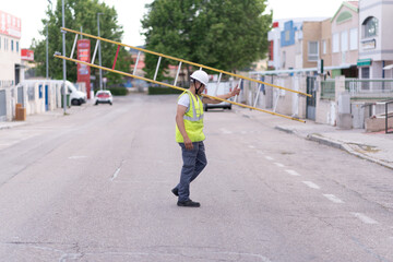 telecommunication technician working at height with ladder and safety helmet