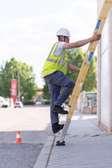 telecommunications technician climbing on fiber ladder