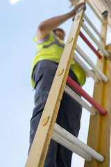 technician working on a yellow ladder