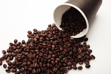 A coffee mug of coffee beans isolated on white