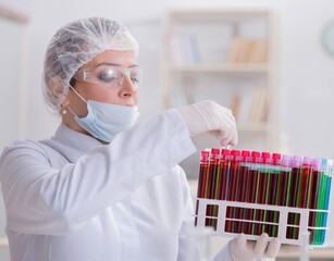 Woman doctor checking blood samples in lab
