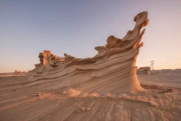 Gordijnen Desert eroded rock pattern with clear sky. Desert rock formation with erosion close up shot. © ManojKumar
