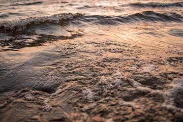 picture of the surface water in the sunset time. The texture of the river water at sunset.