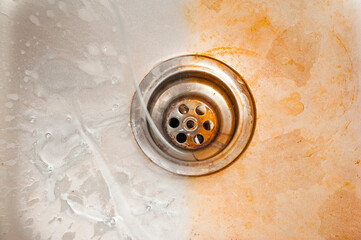 Drain hole of the kitchen sink before and after applying a special solvent detergent