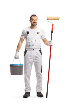 Full length portrait of a painter in a white uniform with a bucket and a paint roller