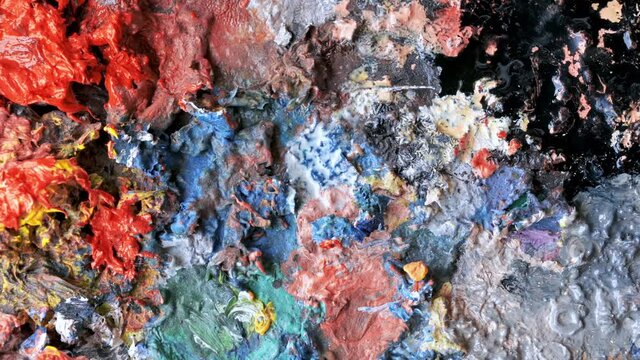 Used palette in a studio with a lot of dry paint on it