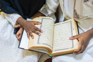 Naklejka premium Siblings reading the Quran 