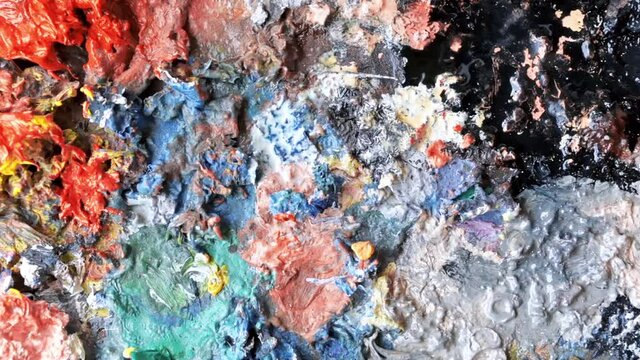 Used palette in a studio with a lot of dry paint on it
