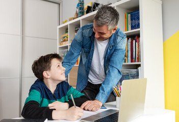 Father helping son finish homework
