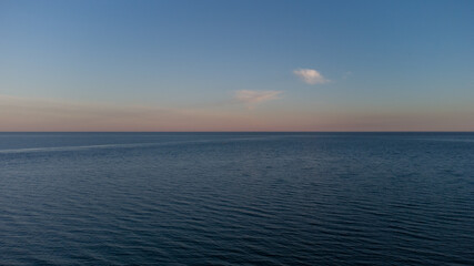 Calm sea at dawn. Blue sea and clouds.