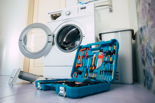 Close up photo of the professional toolbox on fixed washing machine background in the bathroom