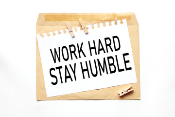 Work Hard, Stay Humble. text on white paper on craft notebook