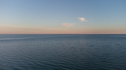 Calm sea at dawn. Blue sea and clouds.