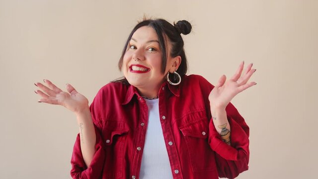 Confused trendy uncertain brunette woman shy shamed spreading hands say i am sorry, oops,  looking puzzled and embarrassed.. Sincere emotions.