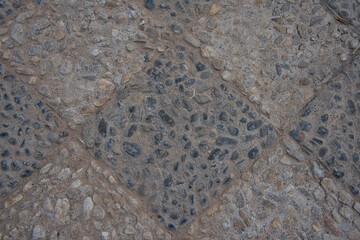 Background of natural stones on tiles with geometric shapes in light and dark